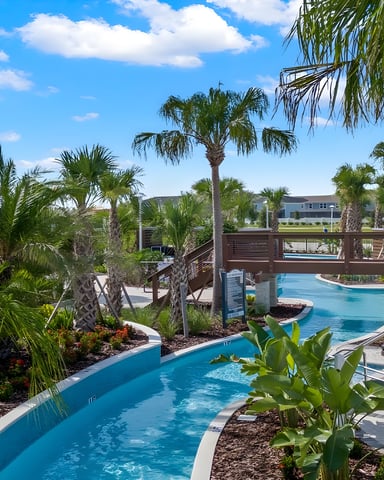 Screened-in pool with turquoise water, spa, lounge chairs, and house at dusk
